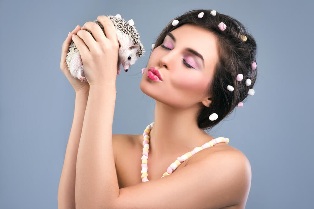 Young woman with small hedgehog